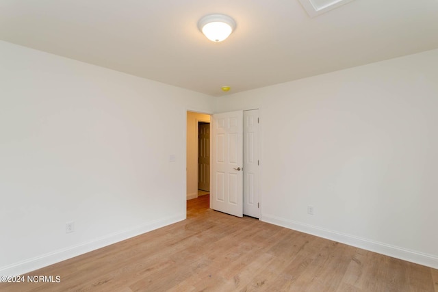 empty room featuring baseboards and light wood-style floors