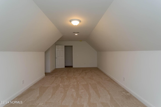 bonus room featuring light carpet, lofted ceiling, visible vents, and baseboards