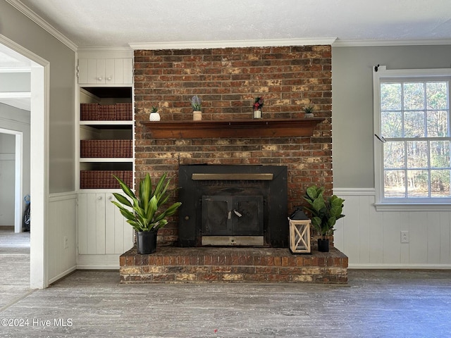 room details featuring hardwood / wood-style flooring, a wood stove, and ornamental molding