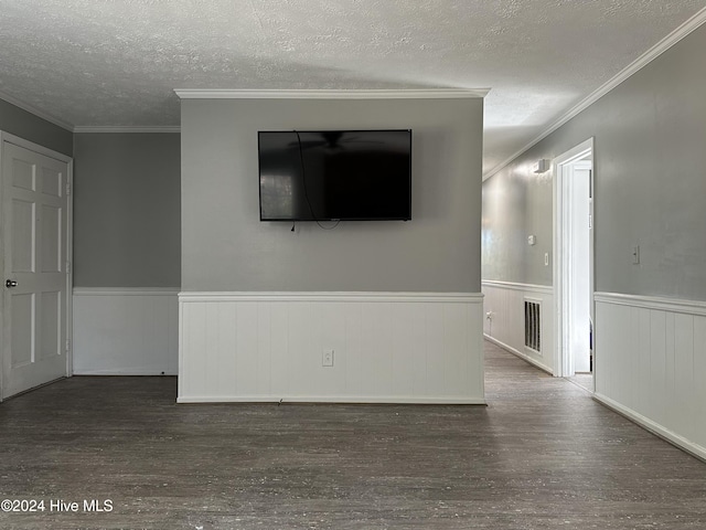 unfurnished room with a textured ceiling, dark hardwood / wood-style floors, and ornamental molding