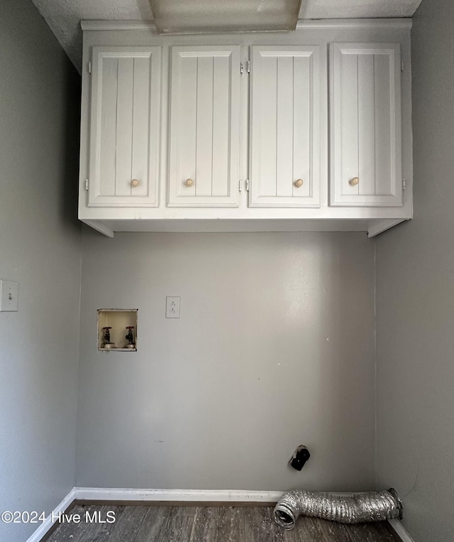 laundry area with dark hardwood / wood-style floors, cabinets, and hookup for a washing machine