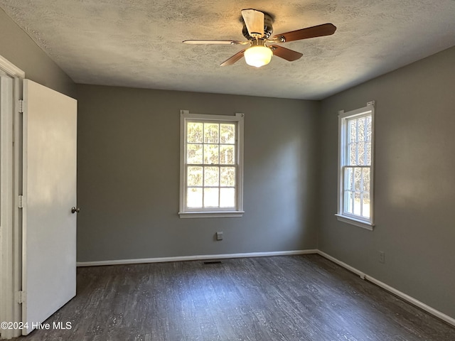 unfurnished room with a textured ceiling, ceiling fan, and dark wood-type flooring