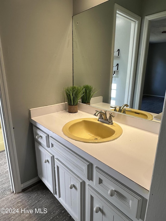 bathroom with vanity and hardwood / wood-style flooring