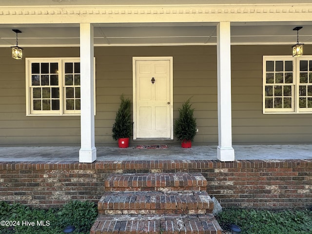 doorway to property featuring a porch