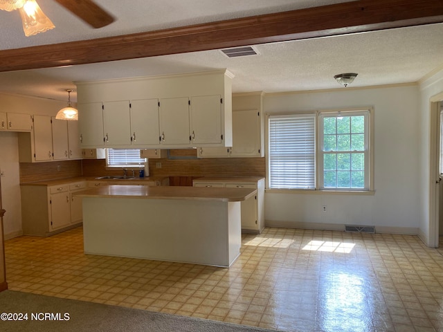 kitchen with decorative light fixtures, white cabinetry, light tile floors, tasteful backsplash, and ceiling fan