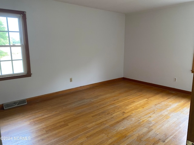 unfurnished room with light wood-type flooring