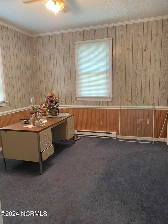 unfurnished office with ornamental molding, dark colored carpet, a baseboard heating unit, and ceiling fan