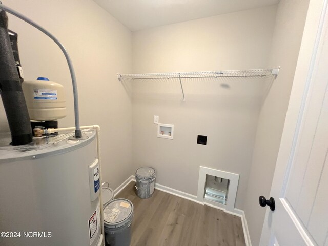 laundry area featuring washer hookup, water heater, hookup for an electric dryer, wood finished floors, and laundry area