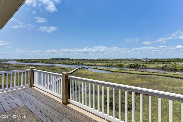 wooden terrace with a water view