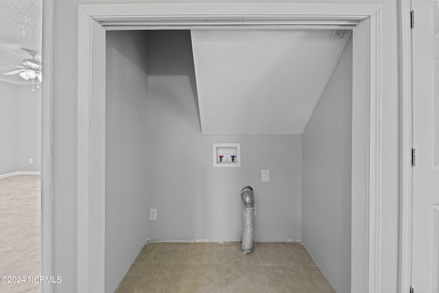 laundry area featuring washer hookup, ceiling fan, light colored carpet, and a textured ceiling