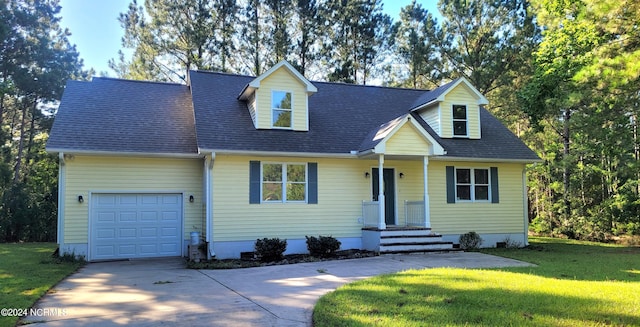 cape cod home featuring a garage and a front yard