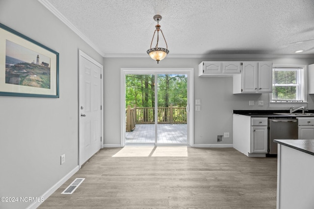 kitchen with dishwasher, decorative light fixtures, light wood-type flooring, white cabinetry, and ornamental molding