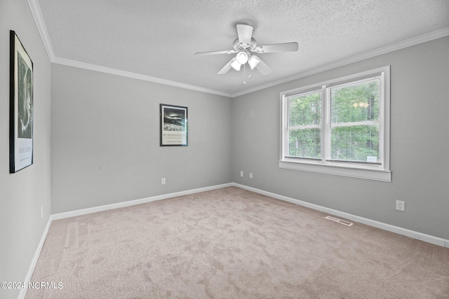 carpeted spare room featuring ornamental molding, a textured ceiling, and ceiling fan