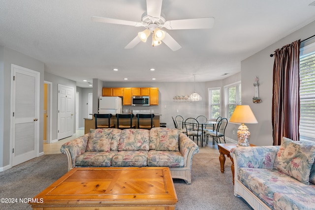 living room with light carpet and ceiling fan