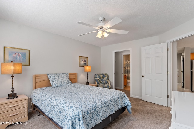 carpeted bedroom with ceiling fan, a textured ceiling, and connected bathroom