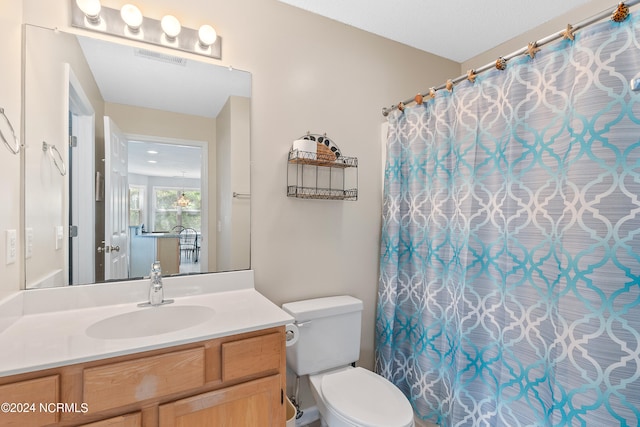 bathroom with large vanity and toilet