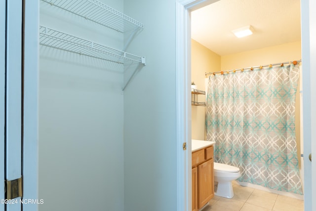 bathroom with vanity, toilet, and tile floors