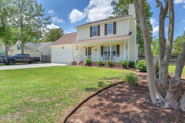 view of front of property with a garage, a front yard, and a porch