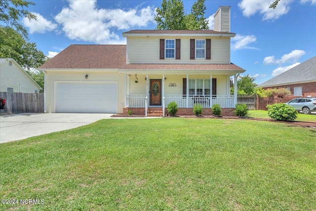 view of front of house featuring a garage, a front yard, and a porch