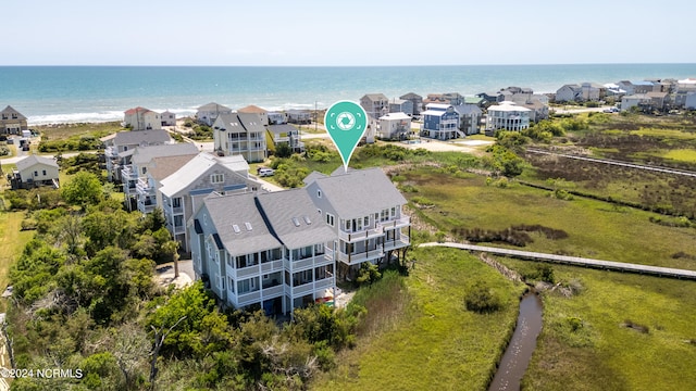 drone / aerial view featuring a water view and a residential view