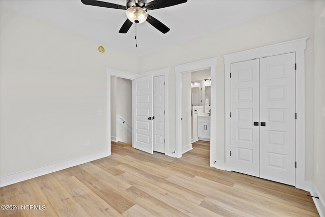 unfurnished bedroom with light wood-style floors, a ceiling fan, baseboards, and connected bathroom