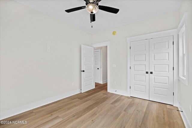 unfurnished bedroom with a ceiling fan, a closet, light wood-style flooring, and baseboards