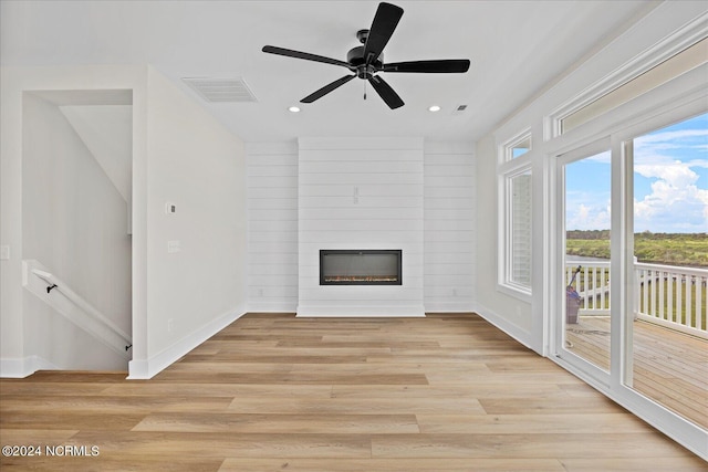 unfurnished living room with visible vents, baseboards, light wood-style flooring, a fireplace, and recessed lighting