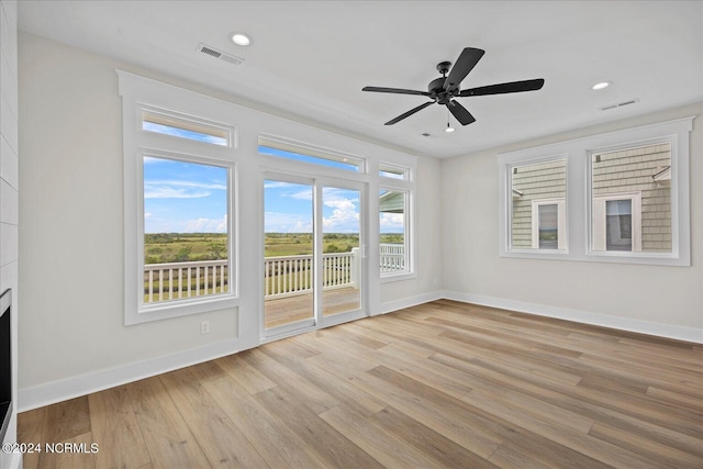 unfurnished living room featuring light wood-type flooring, visible vents, and baseboards