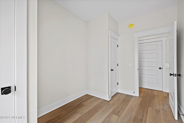 interior space featuring light wood-style flooring and baseboards