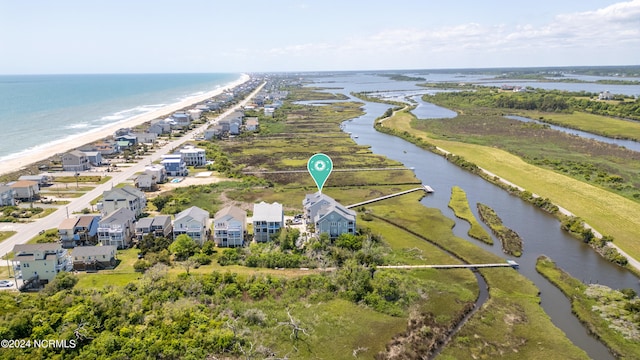 bird's eye view featuring a beach view, a water view, and a residential view