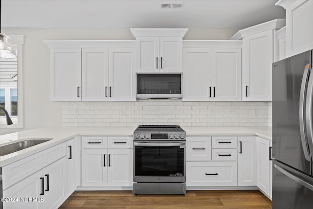 kitchen with light countertops, appliances with stainless steel finishes, and white cabinets