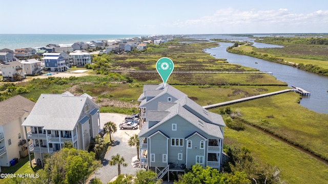 drone / aerial view featuring a residential view and a water view