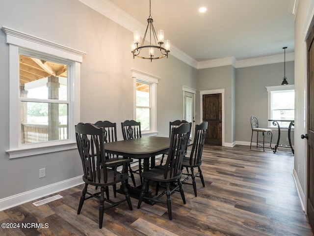 dining space featuring a notable chandelier, crown molding, and dark wood-type flooring