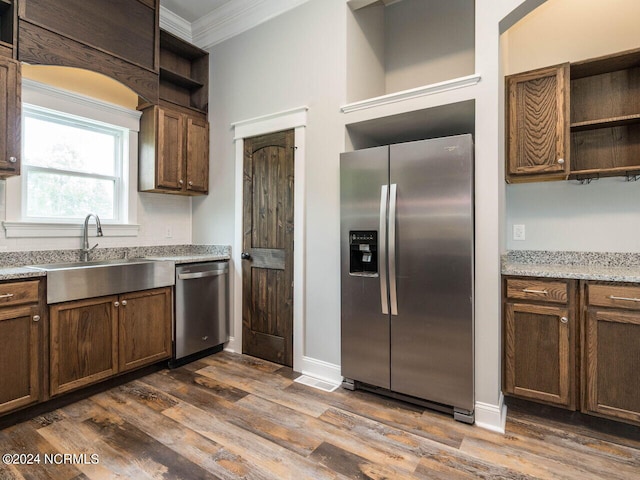 kitchen with crown molding, sink, stainless steel appliances, and dark hardwood / wood-style floors