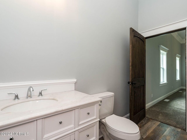 bathroom featuring hardwood / wood-style floors, vanity, and toilet