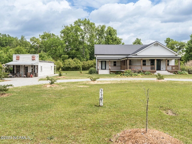 view of front of house with covered porch and a front yard