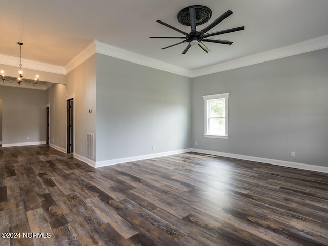 spare room featuring dark wood-type flooring, ceiling fan with notable chandelier, and ornamental molding