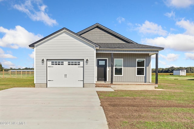 view of front of home featuring a front yard and a garage