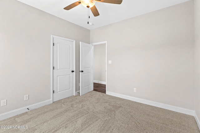 unfurnished bedroom featuring carpet and ceiling fan