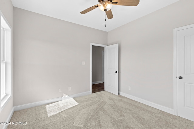 carpeted empty room featuring ceiling fan