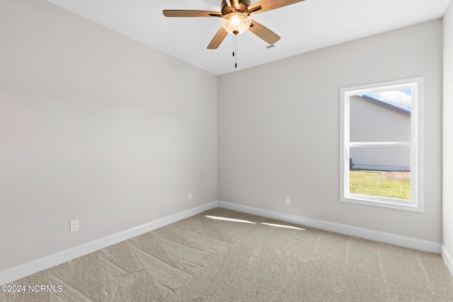 carpeted empty room featuring ceiling fan