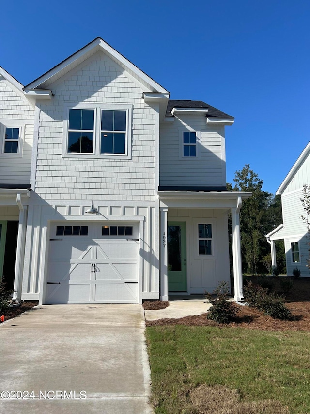 view of front of property with a front yard and a garage