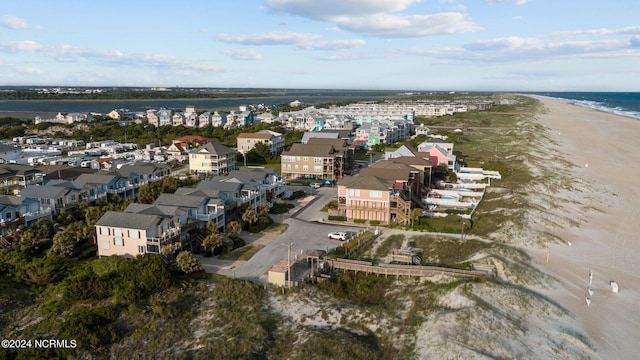 drone / aerial view featuring a water view and a beach view