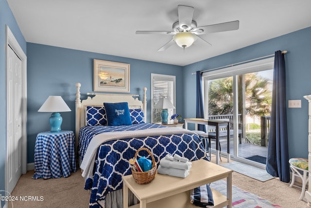 bedroom featuring access to outside, ceiling fan, a closet, and light colored carpet