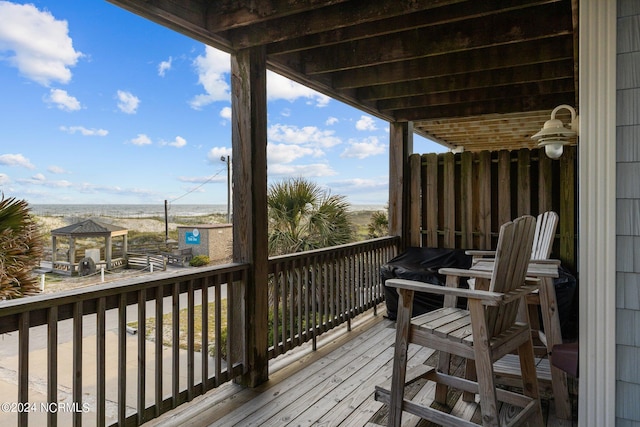 deck featuring a gazebo and a water view