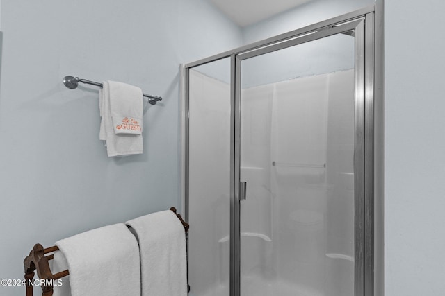 bathroom with a shower with shower door