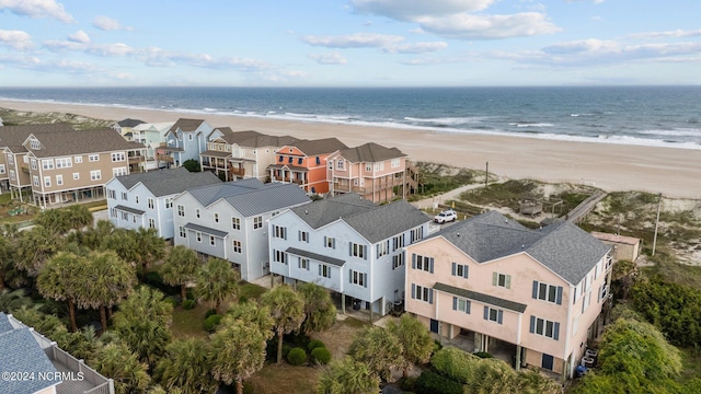 birds eye view of property with a view of the beach and a water view