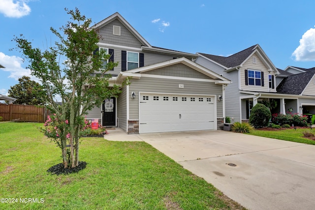 craftsman-style house featuring a garage, central AC unit, and a front lawn