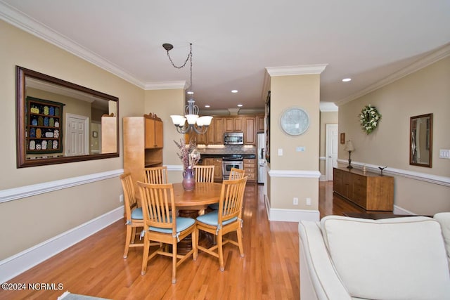 dining space with a notable chandelier, ornamental molding, and light wood-type flooring