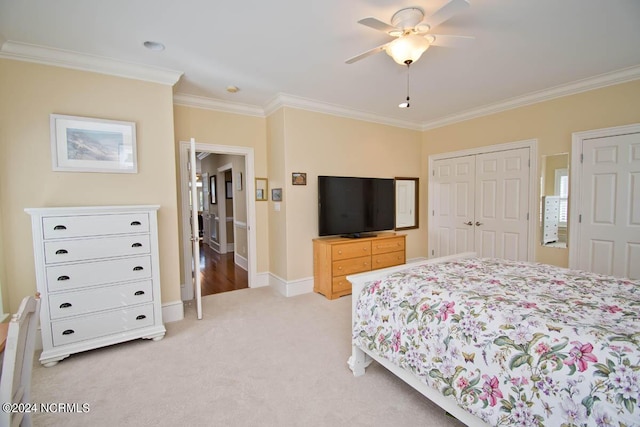 carpeted bedroom with crown molding, ceiling fan, and a closet